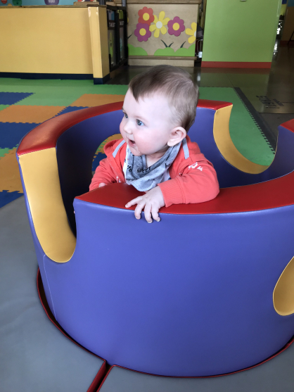 Child playing in the padded foam ring