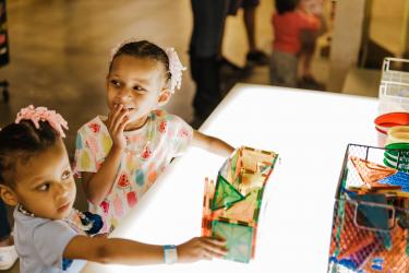 Children playing at the light table