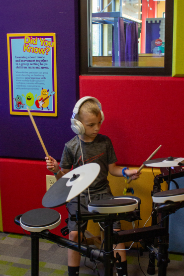 Child on Electronic Drum Set in Sound Studio